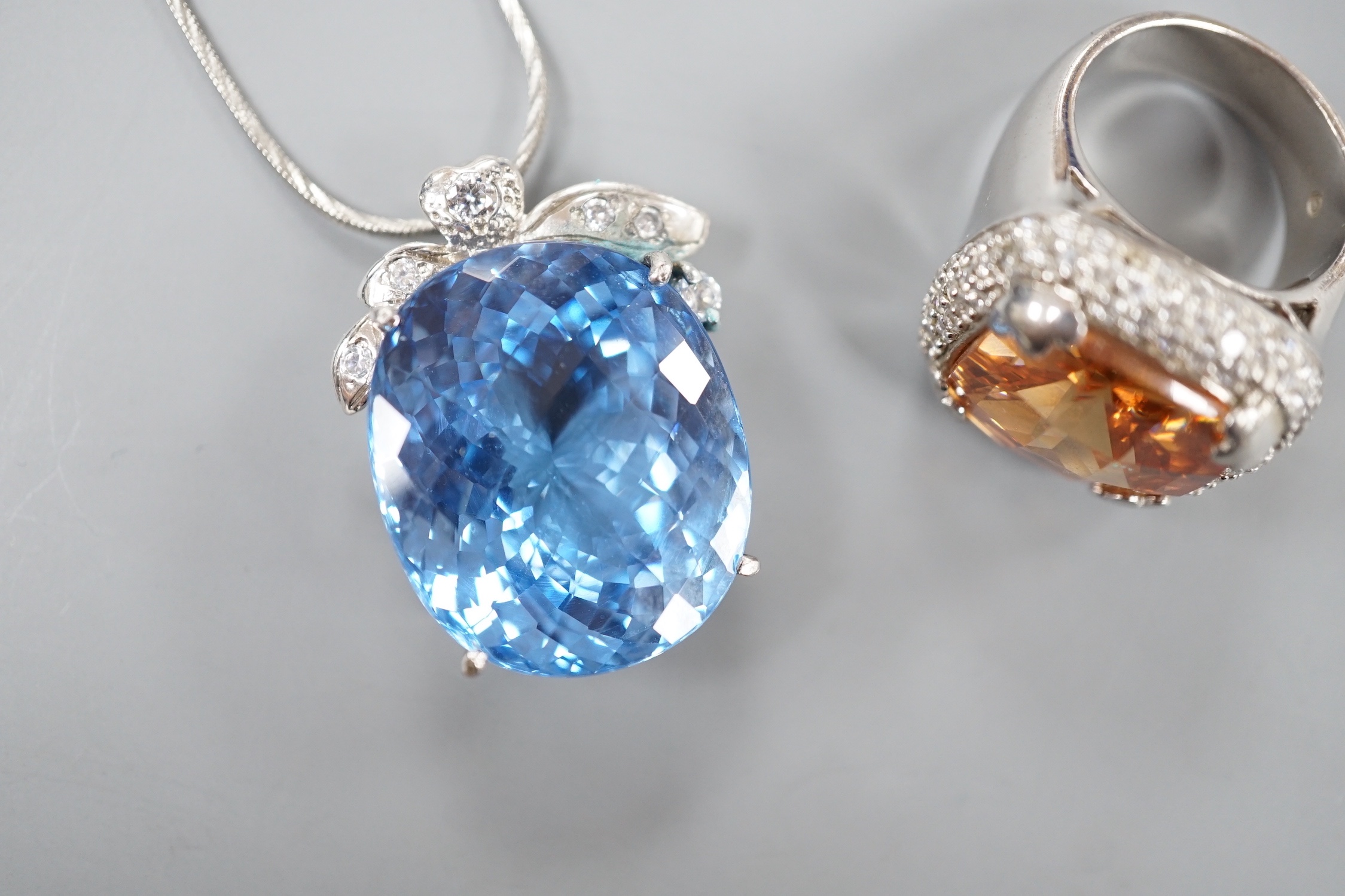 A modern 925 and paste set dress ring and a blue and white paste cluster set pendant on chain.